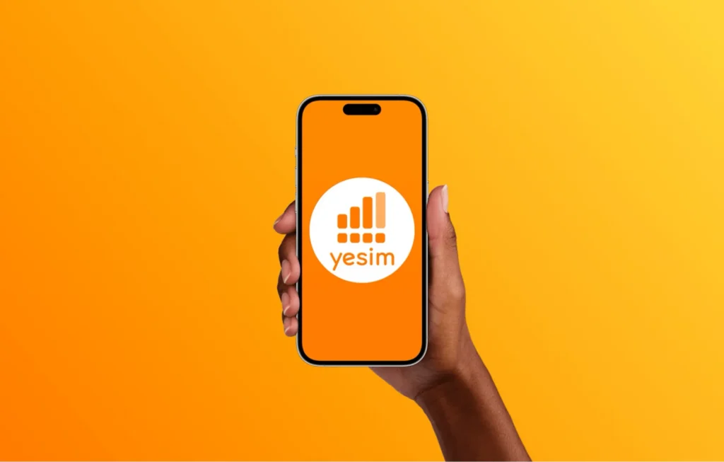 Holding smartphone with yesim esim provider application
